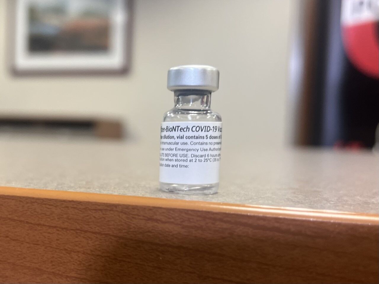 Dr. Jason Smith displays vial of Pfizer vaccine